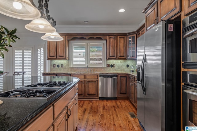 386 N Lake Rd, Birmingham, AL 35242 - kitchen featuring appliances with stainless steel finishes, a sink, wood finished floors, crown molding, and decorative backsplash