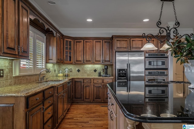 386 N Lake Rd, Birmingham, AL 35242 - kitchen with appliances with stainless steel finishes, a sink, ornamental molding, light stone counters, and wood finished floors