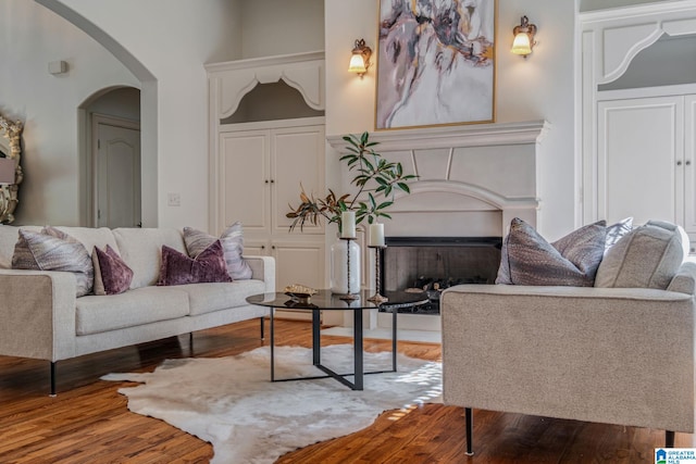 386 N Lake Rd, Birmingham, AL 35242 - living room featuring arched walkways, wood finished floors, and a fireplace