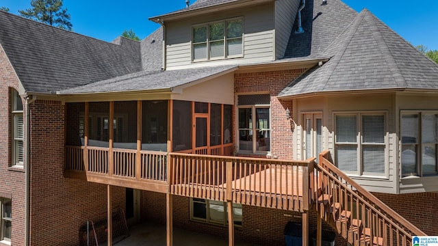 386 N Lake Rd, Birmingham, AL 35242 - rear view of property featuring roof with shingles, brick siding, a sunroom, and a deck