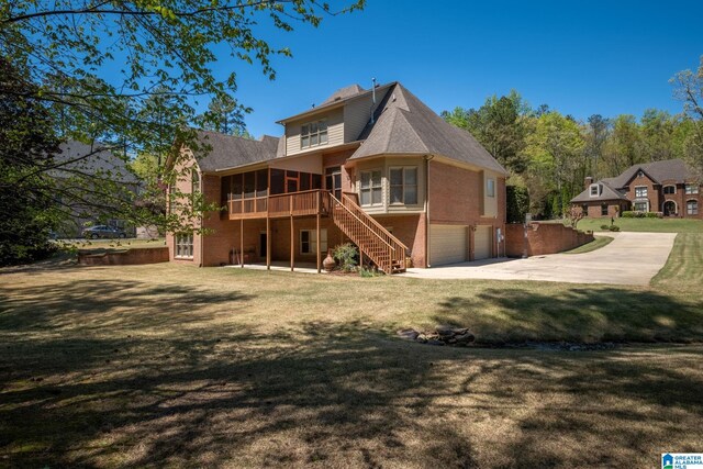 386 N Lake Rd, Birmingham, AL 35242 - rear view of house featuring a sunroom, an attached garage, stairway, brick siding, and concrete driveway