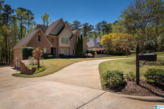 386 N Lake Rd, Birmingham, AL 35242 - traditional home featuring a front lawn, curved driveway, and brick siding