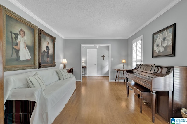 3258 Tyrol Ln, Vestavia Hills, AL 35216 - living area featuring wood finished floors, a textured ceiling, crown molding, and baseboards
