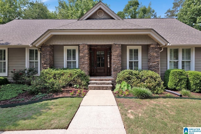 3258 Tyrol Ln, Vestavia Hills, AL 35216 - view of front of home with stone siding, a shingled roof, a front lawn, and a porch