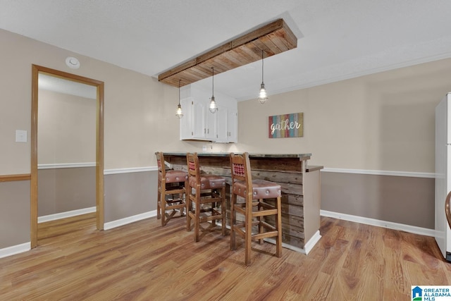 3258 Tyrol Ln, Vestavia Hills, AL 35216 - bar area with light wood-type flooring, baseboards, and hanging light fixtures