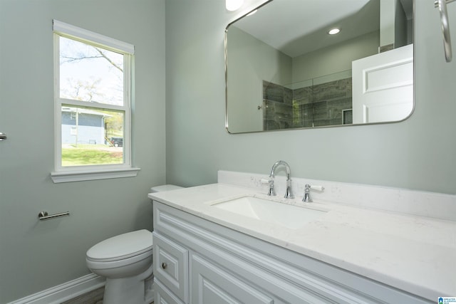 906 6th Ave W, Birmingham, AL 35204 - bathroom featuring vanity, toilet, a tile shower, and baseboards