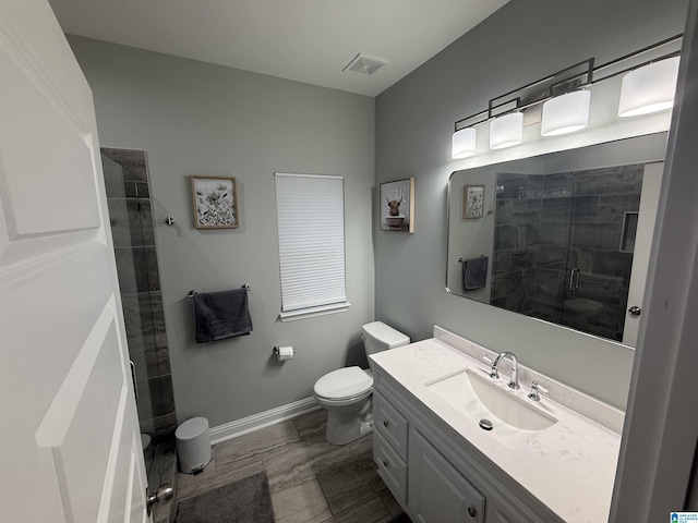 906 6th Ave W, Birmingham, AL 35204 - bathroom featuring toilet, vanity, a stall shower, and baseboards