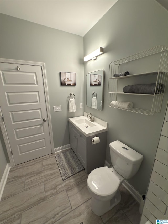 906 6th Ave W, Birmingham, AL 35204 - bathroom with vanity, toilet, and baseboards