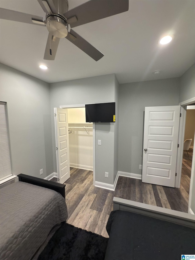 906 6th Ave W, Birmingham, AL 35204 - unfurnished bedroom featuring wood finished floors, recessed lighting, baseboards, a ceiling fan, and a walk in closet