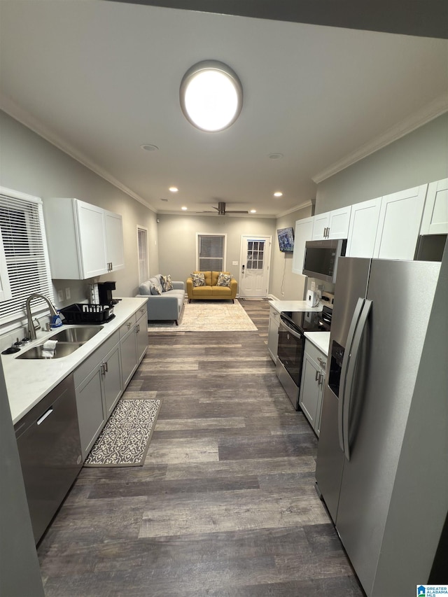 906 6th Ave W, Birmingham, AL 35204 - kitchen with appliances with stainless steel finishes, a sink, crown molding, light countertops, and dark wood-type flooring