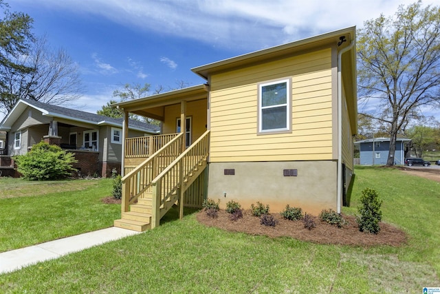906 6th Ave W, Birmingham, AL 35204 - view of front of house with a front yard, crawl space, covered porch, and stairway