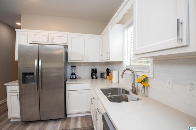 539 63rd St S, Birmingham, AL 35212 - kitchen with stainless steel fridge with ice dispenser, a sink, white cabinets, wood finished floors, and light countertops
