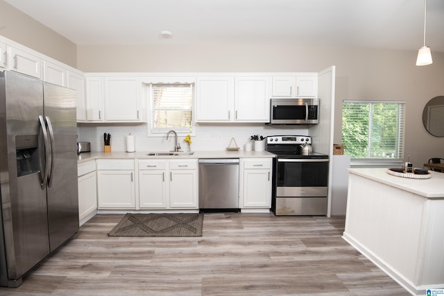 539 63rd St S, Birmingham, AL 35212 - kitchen featuring appliances with stainless steel finishes, a sink, white cabinetry, and light countertops
