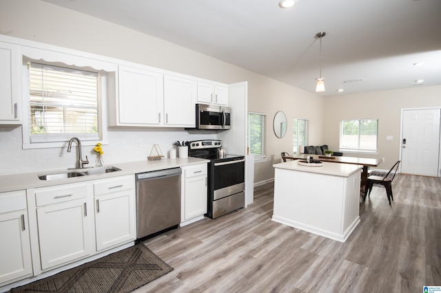 539 63rd St S, Birmingham, AL 35212 - kitchen with appliances with stainless steel finishes, a sink, light wood-style floors, white cabinetry, and recessed lighting