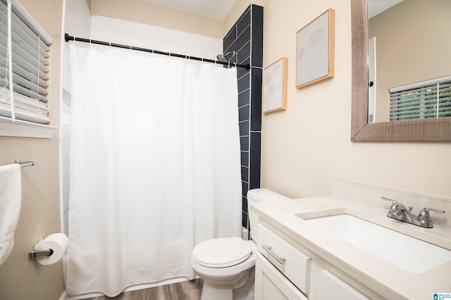 539 63rd St S, Birmingham, AL 35212 - full bathroom with vanity, toilet, a shower with curtain, and wood finished floors