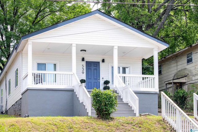539 63rd St S, Birmingham, AL 35212 - shotgun-style home with stairway, a porch, and central air condition unit