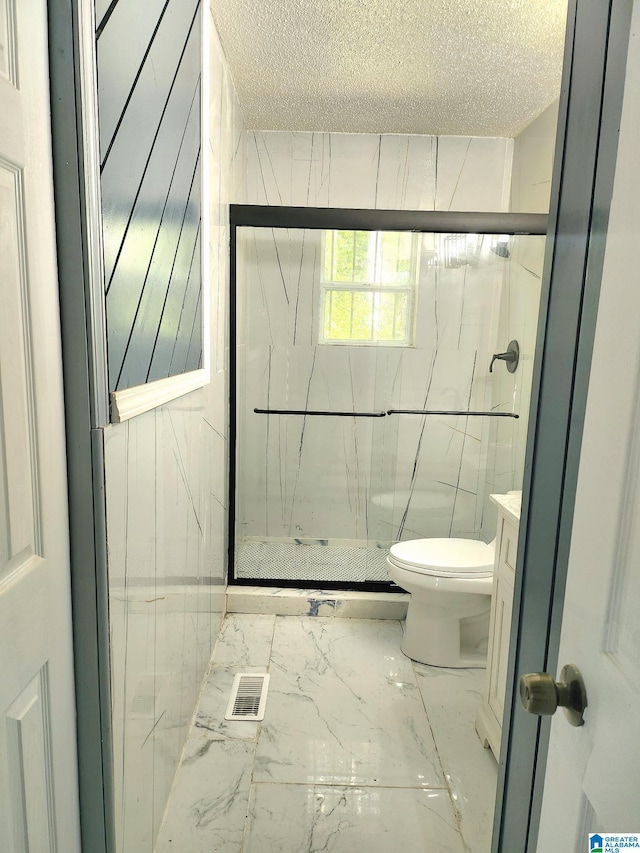 2125 Henry Crumpton Dr, Birmingham, AL 35211 - bathroom with toilet, a marble finish shower, marble finish flooring, a textured ceiling, and vanity