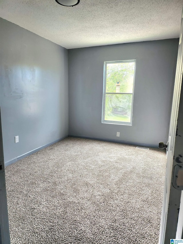2125 Henry Crumpton Dr, Birmingham, AL 35211 - empty room with carpet flooring and a textured ceiling