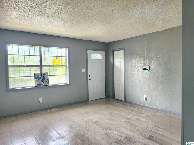 2125 Henry Crumpton Dr, Birmingham, AL 35211 - foyer entrance featuring wood finished floors, a textured ceiling, baseboards, and a textured wall