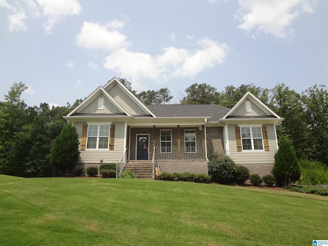 363 Asbury Way, Odenville, AL 35120 - view of front of house featuring brick siding, a front yard, board and batten siding, and covered porch