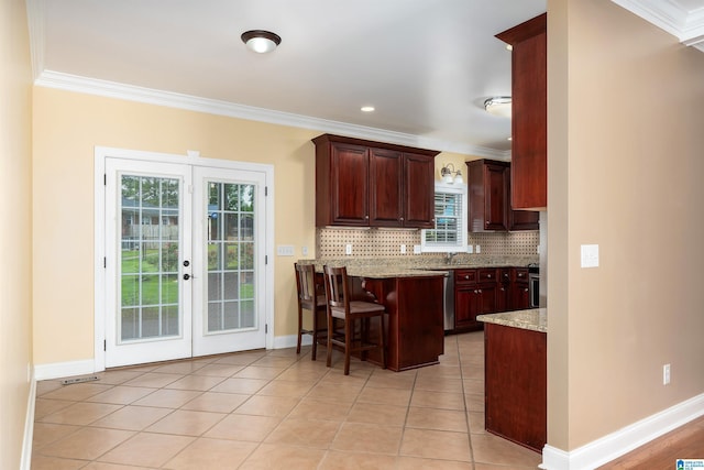 101 Mill Rd, Springville, AL 35146 - kitchen featuring crown molding, tasteful backsplash, a kitchen bar, a peninsula, and french doors