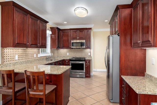 101 Mill Rd, Springville, AL 35146 - kitchen featuring appliances with stainless steel finishes, a peninsula, crown molding, decorative backsplash, and light tile patterned floors