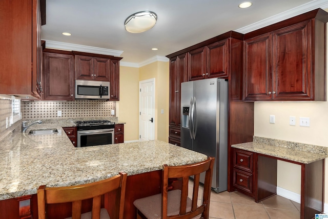 101 Mill Rd, Springville, AL 35146 - kitchen with appliances with stainless steel finishes, ornamental molding, a peninsula, light stone counters, and recessed lighting
