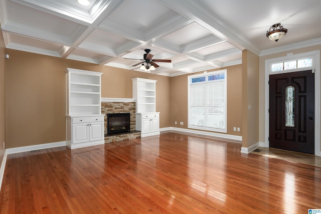 101 Mill Rd, Springville, AL 35146 - unfurnished living room with light wood-type flooring, healthy amount of natural light, a ceiling fan, a fireplace, and beamed ceiling