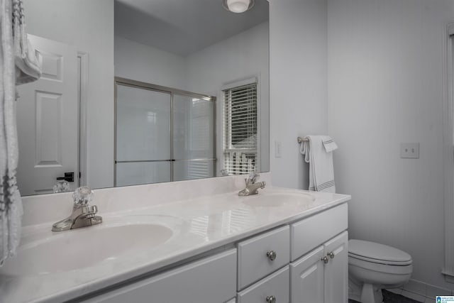 429 Eaton Rd, Hoover, AL 35242 - bathroom featuring toilet, double vanity, and a shower with door