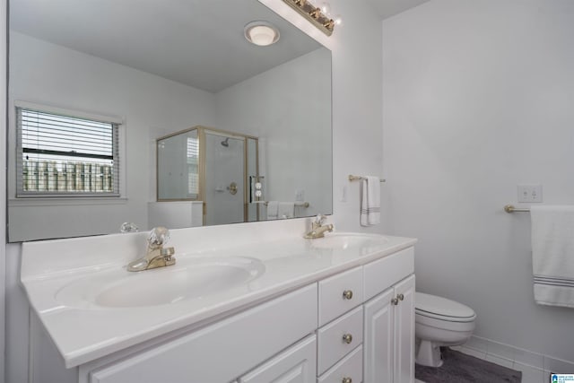 429 Eaton Rd, Hoover, AL 35242 - bathroom with double vanity, toilet, a stall shower, and tile patterned floors