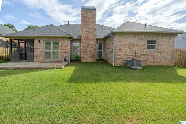 429 Eaton Rd, Hoover, AL 35242 - back of house with a sunroom, a shingled roof, brick siding, central air condition unit, and a chimney