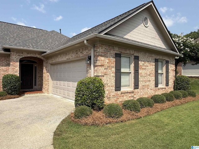 429 Eaton Rd, Hoover, AL 35242 - view of side of property with an attached garage, driveway, brick siding, a shingled roof, and a yard