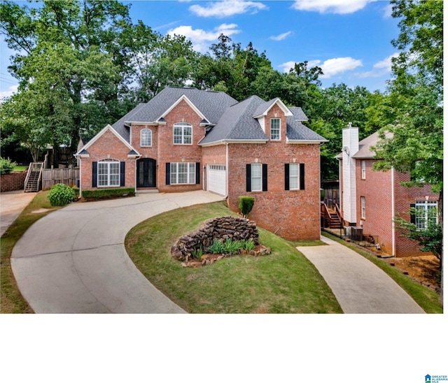 4728 Red Leaf Cir, Hoover, AL 35226 - view of front facade featuring driveway, stairway, brick siding, a front lawn, and a garage