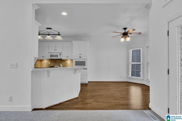 4728 Red Leaf Cir, Hoover, AL 35226 - kitchen with white appliances, white cabinets, ceiling fan, a breakfast bar, and baseboards