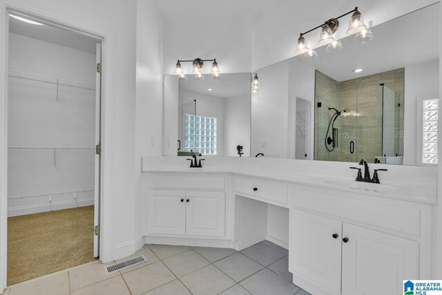 4728 Red Leaf Cir, Hoover, AL 35226 - full bathroom with a stall shower, double vanity, a spacious closet, and tile patterned flooring