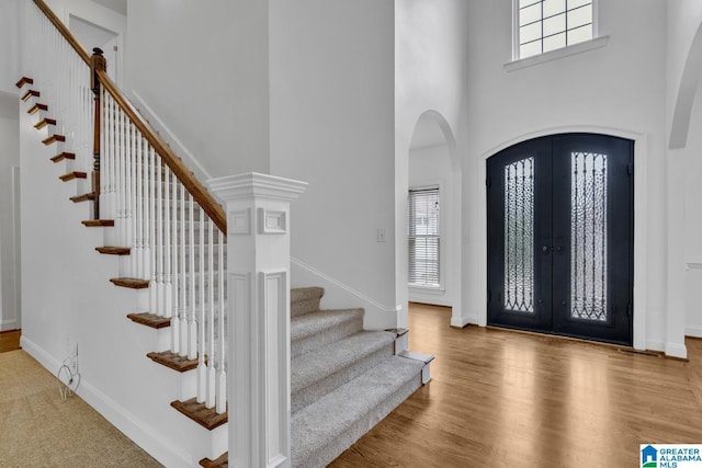 4728 Red Leaf Cir, Hoover, AL 35226 - entrance foyer with a high ceiling, stairway, arched walkways, french doors, and wood finished floors