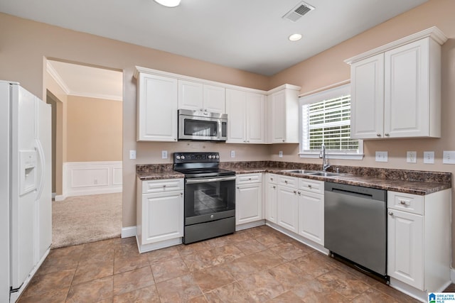 538 Forest Lakes Dr, Sterrett, AL 35147 - kitchen featuring appliances with stainless steel finishes, a sink, dark countertops, white cabinetry, and crown molding