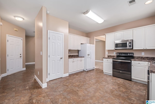 538 Forest Lakes Dr, Sterrett, AL 35147 - kitchen featuring stainless steel microwave, black / electric stove, white refrigerator with ice dispenser, and baseboards