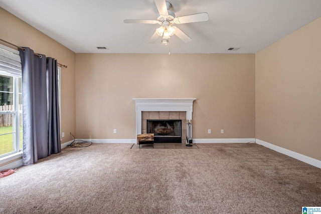 538 Forest Lakes Dr, Sterrett, AL 35147 - unfurnished living room with carpet, a ceiling fan, a tiled fireplace, and baseboards