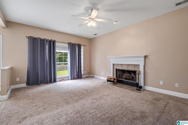 538 Forest Lakes Dr, Sterrett, AL 35147 - unfurnished living room featuring carpet floors, a ceiling fan, a tile fireplace, and baseboards