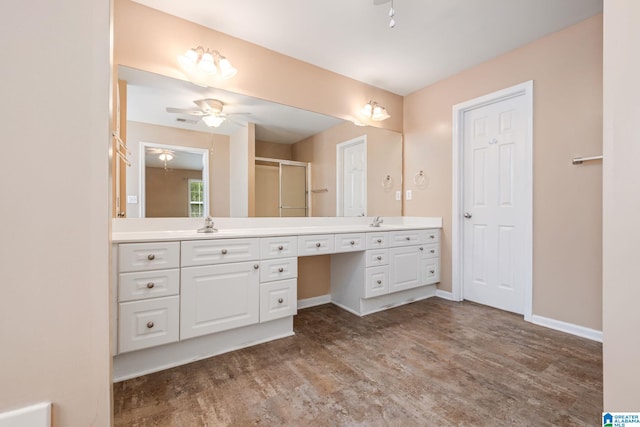 538 Forest Lakes Dr, Sterrett, AL 35147 - bathroom featuring double vanity, a stall shower, a ceiling fan, wood finished floors, and baseboards