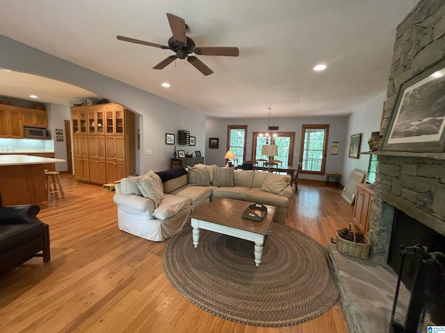 720 Good Hope Delta Rd, Delta, AL 36258 - living area with light wood-type flooring, a ceiling fan, arched walkways, recessed lighting, and a fireplace