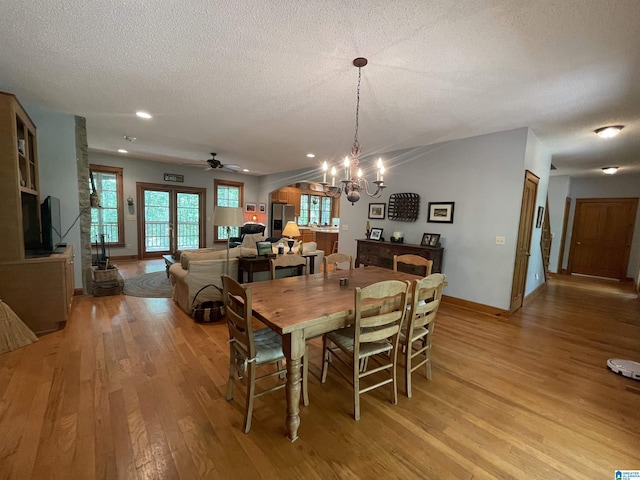 720 Good Hope Delta Rd, Delta, AL 36258 - dining room with light wood-style floors, a chandelier, a textured ceiling, ceiling fan, and baseboards
