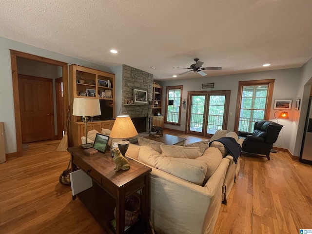 720 Good Hope Delta Rd, Delta, AL 36258 - living area with a stone fireplace, light wood-type flooring, a ceiling fan, baseboards, and recessed lighting