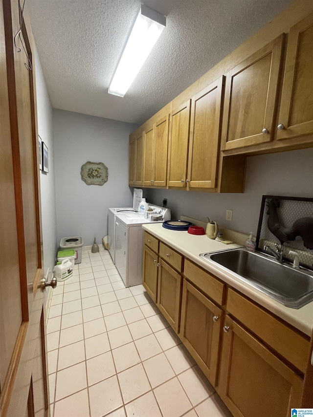 720 Good Hope Delta Rd, Delta, AL 36258 - laundry room featuring cabinet space, washing machine and dryer, a textured ceiling, and light tile patterned floors