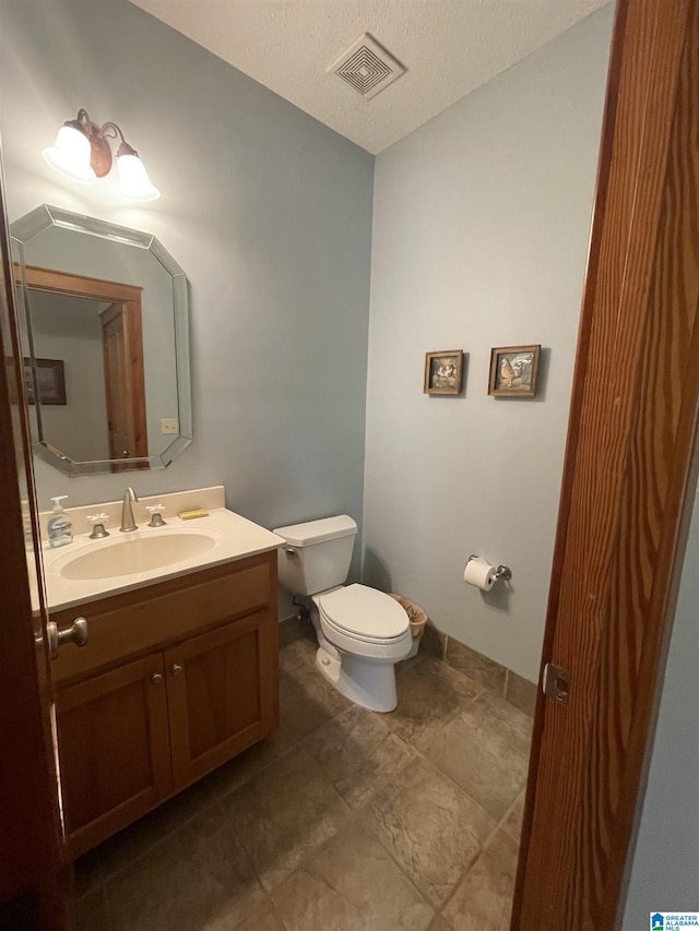 720 Good Hope Delta Rd, Delta, AL 36258 - bathroom featuring toilet, vanity, and baseboards