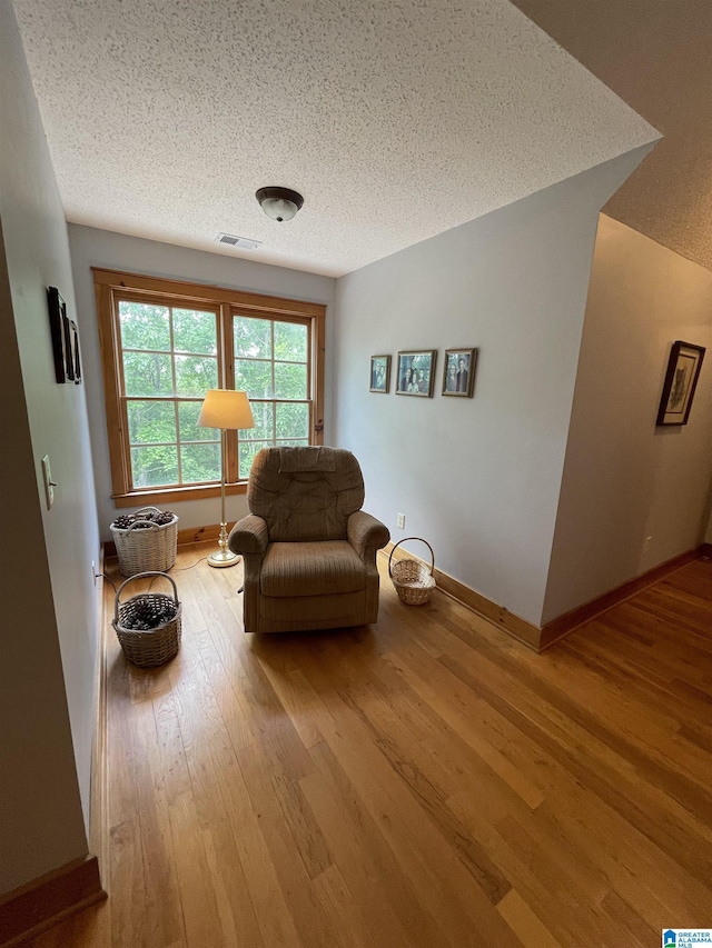 720 Good Hope Delta Rd, Delta, AL 36258 - sitting room featuring wood finished floors, a textured ceiling, and baseboards