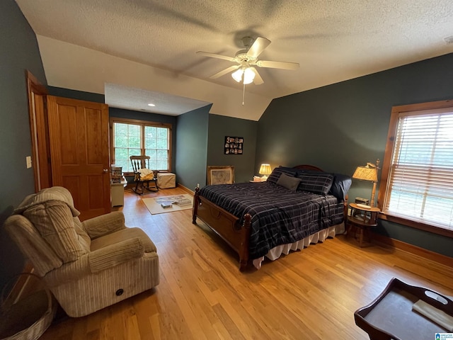 720 Good Hope Delta Rd, Delta, AL 36258 - bedroom with wood finished floors, a textured ceiling, vaulted ceiling, baseboards, and ceiling fan