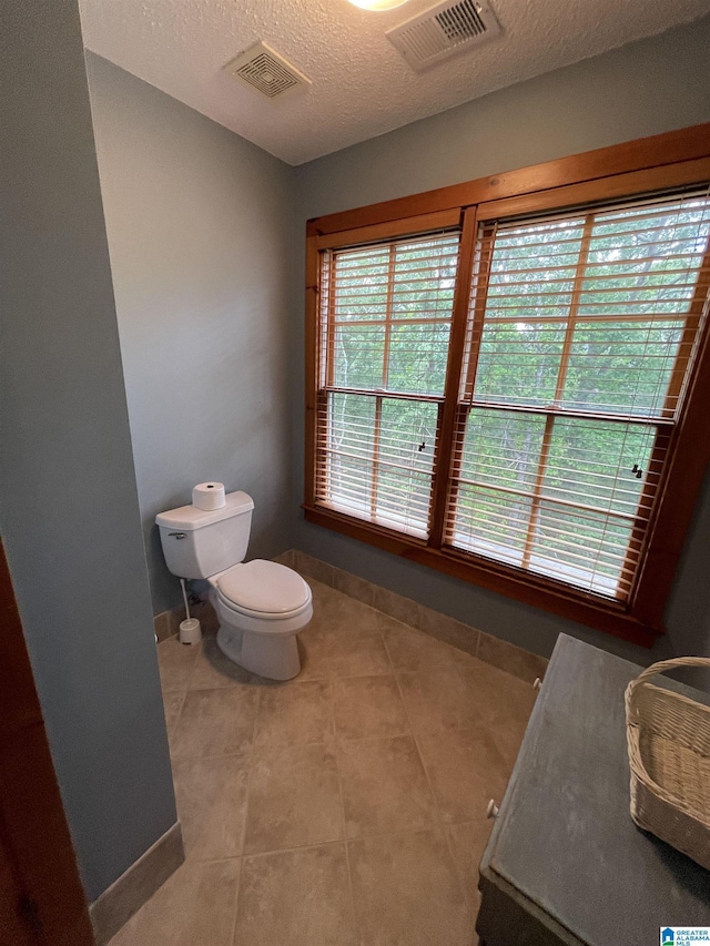720 Good Hope Delta Rd, Delta, AL 36258 - bathroom with baseboards, toilet, tile patterned floors, and a textured ceiling