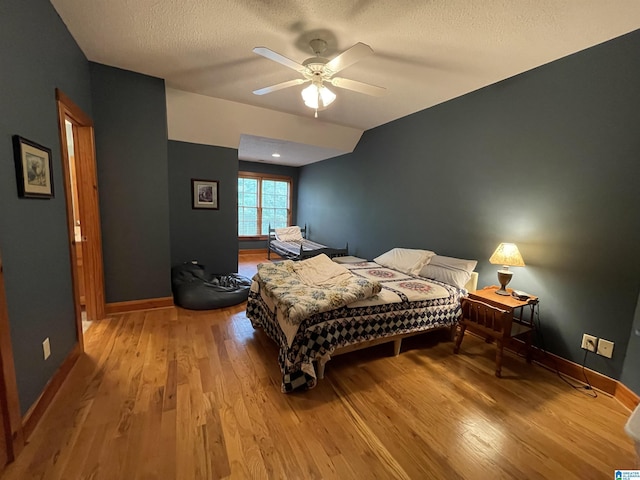 720 Good Hope Delta Rd, Delta, AL 36258 - bedroom featuring light wood-type flooring, baseboards, a textured ceiling, and a ceiling fan